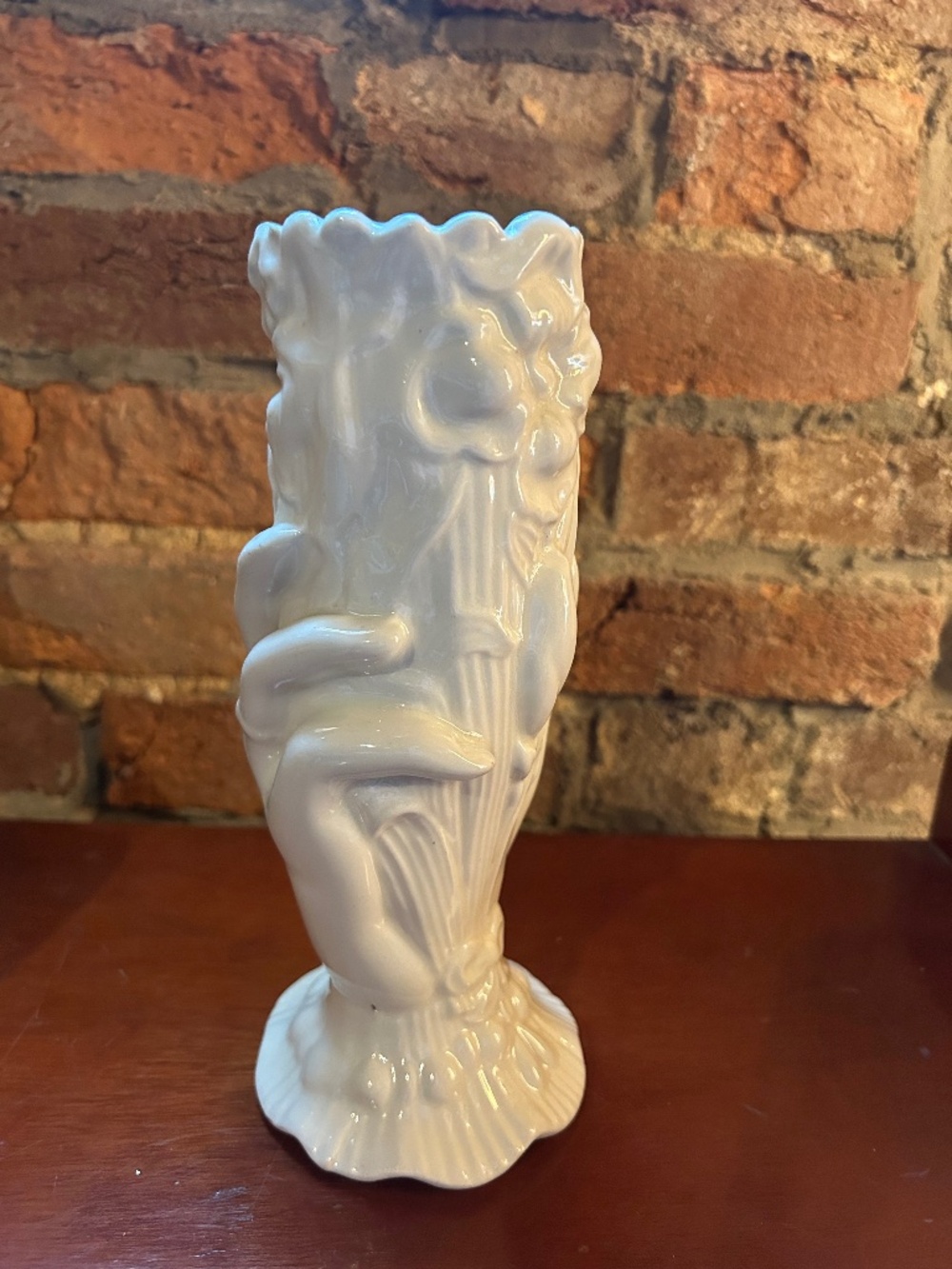 Vintage ceramic hand holding flowers vase